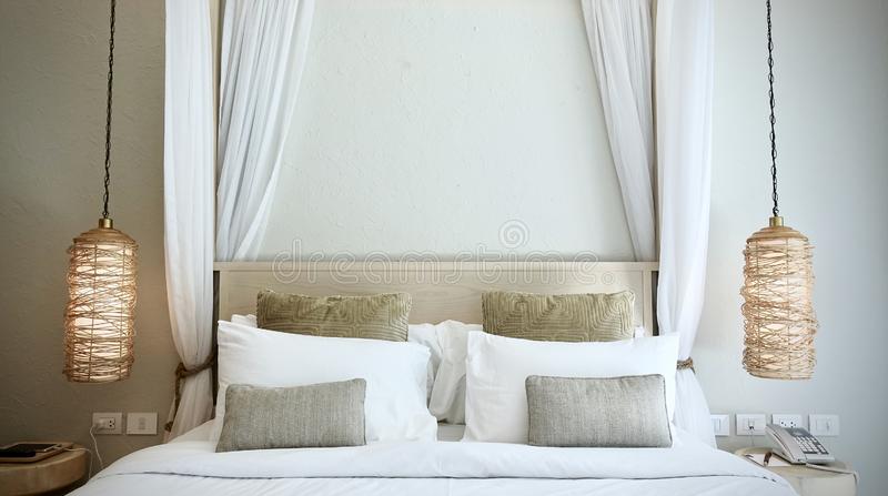 warm-atmosphere-around-bedroom-resort-style-hotel-white-bedsheet-white-brown-pillows-warm-atmosphere-around-bedroom-131214196